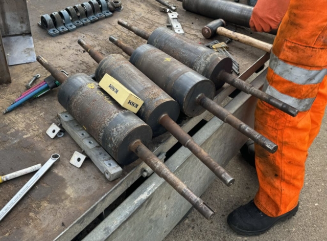 Four worn rollers which require metal spraying to rebuild bearing journals